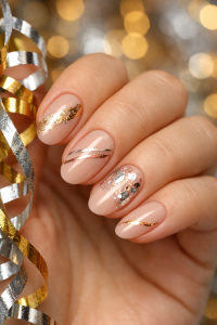New Year's Eve nails in Airdrie, nude gel manicure with mixed metallic gold silver and rose gold foil and striping on short almond nails, holding shiny party ribbons at Top Nails 3
