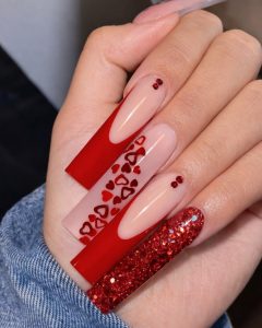 Valentine Nails with nude base, thin red line details, tiny red hearts, and one solid red accent nail, almond shape, Top Nails 3