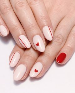 Valentine Nails nude base with red heart accents and minimal red details, glossy finish, Top Nails 3