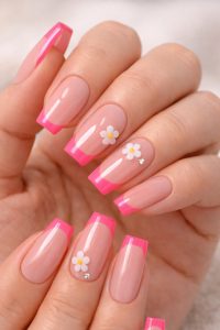 Glossy nude pink square nails with hot pink French tips, white daisy flower accents, and small rhinestone details, Nail Trends 2026 at Top Nails 3 Airdrie