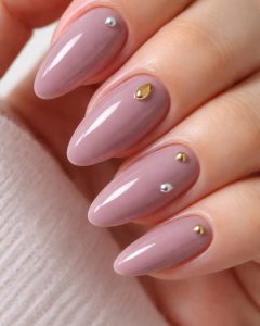 Soft mauve almond nails with gold and silver stud accents, International Women’s Day Nail Trends 2026 Top Nails 3