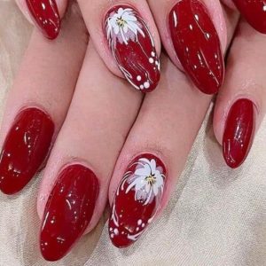 Red almond nails with white floral painting and glossy finish Floral Nails 2026 at Top Nails 3 Airdrie