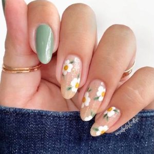 Almond nude glitter nails with white daisy floral art and sage green accent Floral Nails 2026 at Top Nails 3 Airdrie