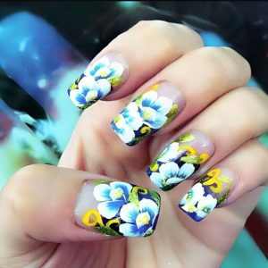 Square nails with bold blue floral painting and gold accents Floral Nails 2026 at Top Nails 3 Airdrie