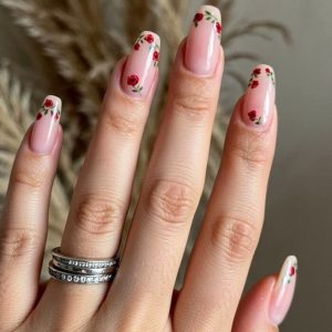 Soft pink almond nails with tiny red rose floral accents Floral Nails 2026 at Top Nails 3 Airdrie