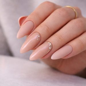 Mix texture nails with nude almond shape and gold crystal accents at Top Nails 3 Airdrie