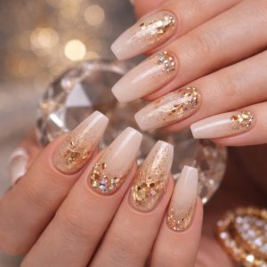 Mix texture nails with nude ombre base, gold foil flakes, glitter accents, and rhinestones on long coffin-shaped nails at Top Nails 3 Airdrie